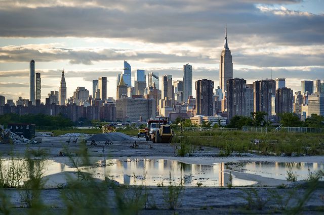 a damp construction site with the Manhattan skyline in the background